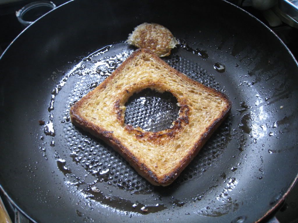 Pan toasting bread for eggs in a basket